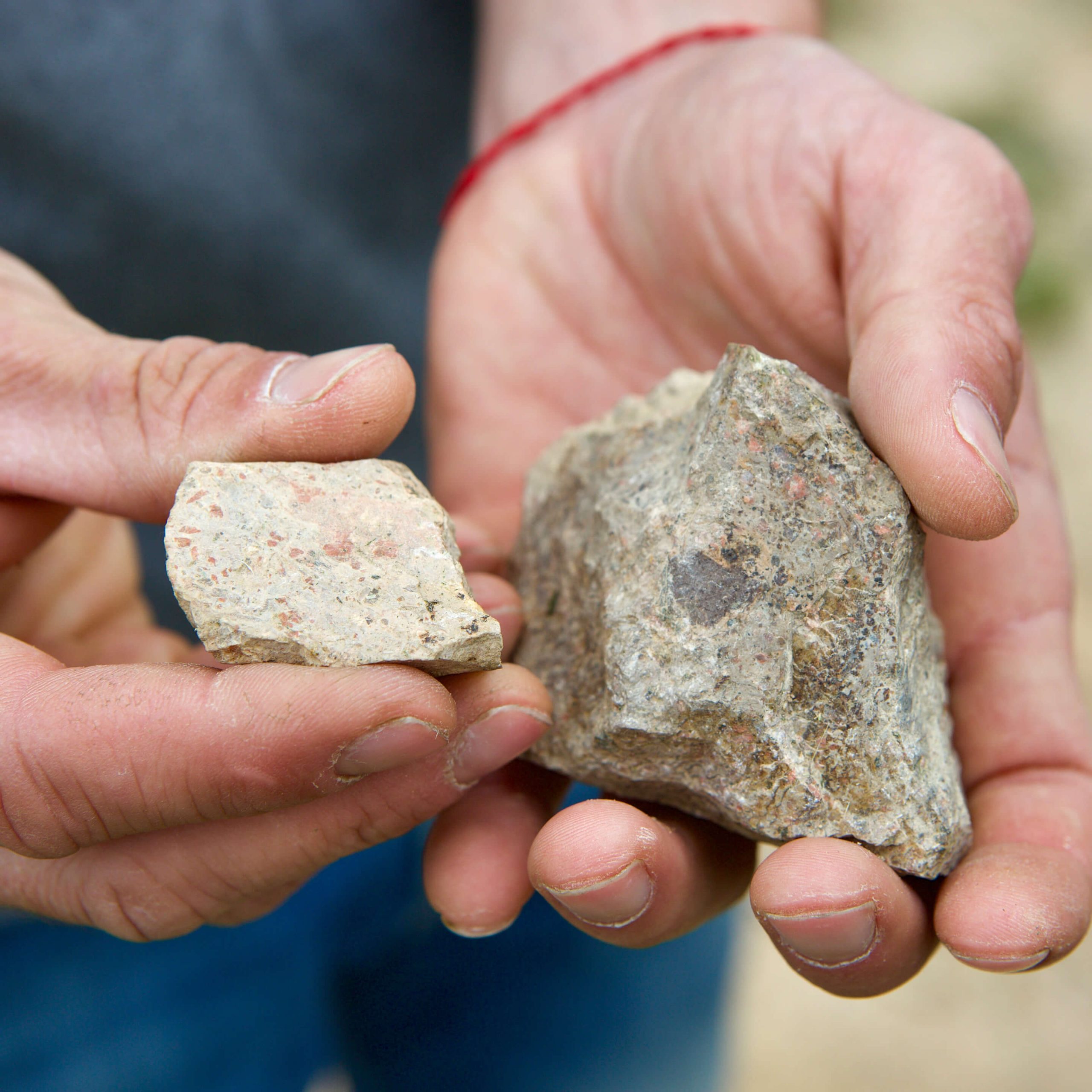 Volcanic rocks from Davide Carlone's vineyards in Boca, Alto Piemonte, and the hands of Cristiano Garella.